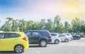 Cars parking in asphalt parking lot in a row with blue sky background. Outdoor parking lot with fresh ozone, green nature environm Royalty Free Stock Photo