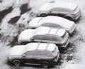 Cars in the parking lot covered in sticky snow