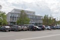 Cars are in the parking lot in front of the court building of the Krasnoyarsk Territory, on Mira Avenue on a spring cloudy day