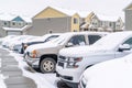 Cars in the parking lot of a neighborhood against homes and apartments in winter