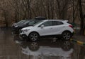 Cars in a parking lot in the rain in the spring