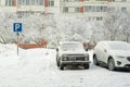 Cars in the parking lot in winter. Disabled parking sign Royalty Free Stock Photo