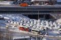 Cars on parking and street covered with big snow layer. View of winter and snowing on city street with snowflakes.