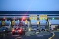 Cars pass through illuminated Telepass toll gates on Italian highway