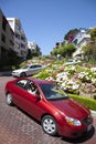 Cars passing the Lombard street in San Francisco. It is  known for the  section on Russian Hill between Hyde and Leavenworth, in Royalty Free Stock Photo