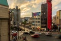 Cars and pedestrians travel on and along a street of Fukuoka, Japan on a rainy evening Royalty Free Stock Photo