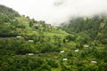 Cars ride by mountain road from coastal village