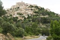 Cars on road below mougins french hill town