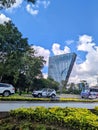 Cars on the road and a unique modern skyscraper in downtown Mexico City