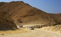 Cars on a rocky rough road in a wadi Royalty Free Stock Photo