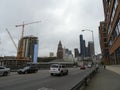 Cars roll down street by Seattle King Street Station and construction