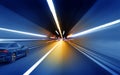 Cars rush through the tunnel in the beams of searchlights. Royalty Free Stock Photo