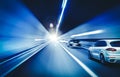 Cars rush through the tunnel in the beams of searchlights. Royalty Free Stock Photo