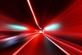 Cars rush through the tunnel in the beams of searchlights. Royalty Free Stock Photo