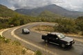 Cars on serpentine road in mountains