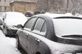 Cars in snow at the streets. First snow in the city. Traffic in winter. Bad weather and transport. Snow covered car. Royalty Free Stock Photo