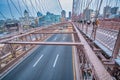 Cars speeding at sunset on Brooklyn Bridge at sunset, Manhattan. One of the most iconic bridges in the world, NY - USA Royalty Free Stock Photo