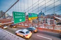 Cars speeding at sunset on Brooklyn Bridge at sunset, Manhattan. One of the most iconic bridges in the world, NY - USA Royalty Free Stock Photo