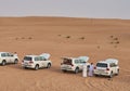 Cars stand in the desert getting ready for a jeep safari, transportation of the United Emirates