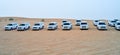 Cars stand in the desert getting ready for a jeep safari, transportation of the United Emirates