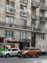 Cars stand near the old facade of the building