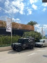 Cars stand on the side of the building with a sign