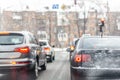 Cars standing in row in traffic jam on city street on slippery snowy road in winter. Vehicles get stuck on road during rush hour a Royalty Free Stock Photo