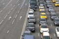 Cars standing in a traffic jam on one side of a busy highway. Transportation rush hour in a city. Royalty Free Stock Photo