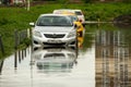 Cars stuck in big puddle after heavy rain