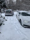 2 cars stuck in the snow in driveway