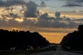 Cars stuck in traffic at dramatic sundown time