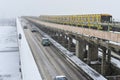 Cars and a subway train move across the Metro bridge Royalty Free Stock Photo