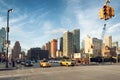 Cars and taxi crossing the intersection of 34th St and 11th along the construction site of 3 Hudson Boulevard