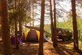 cars, tents, and camping in the woods. Family outdoor recreation, travel concept Royalty Free Stock Photo