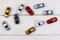 Cars toys on white wooden background. Top view Royalty Free Stock Photo