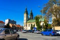 Cars in traffic in downtown near orthodox church of Lugoj, Romania, 2020