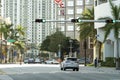 Cars traffic driving at intersection on American street with traffic lights in Miami, Florida. USA transportation Royalty Free Stock Photo
