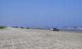 Cars, Trucks and SUV`s line up on the white sandy Beach of Padre Island, near Corpus Christi in Texas. Royalty Free Stock Photo