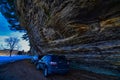 Cars parked under the overhanging cliffs at pier County park