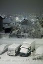 Cars under the snow in the parking lot