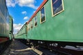 Between cars of vintage trains, between two old trains, old green wagons