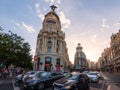 Cars waiting for traffic-light at the street cross Calle de Alcala and Gran Via at sunny evening in Madrid, Spain