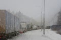 Cars on winter road traffic jam city. Winter weather on the city highway, the view from police car patrol through steamy glass Royalty Free Stock Photo