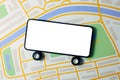 Carsharing, car rental and taxi service mobile app - phone with wheels and blank screen on city map