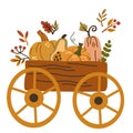 Cart with autumn harvest. Wooden farm cart with leaves and pumpkins. Composition for a poster or postcard.