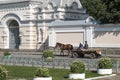 A cart drawn by a horse walks down the street past the Orthodox Holy Trinity patriarchal Convent in Korets, Ukraine.