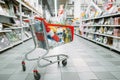 Cart full of goods in supermarket, nobody