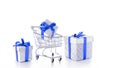 Xmas gift. Trolley cart for supermarket with christmas or birthday gift box isolated on white background. Creative idea for