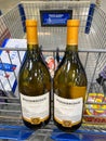 A cart with two bottles of Woodbridge Robert Mondavi Chardonnay wine at a Sams Club in