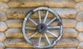 Cart wheel on log wall Royalty Free Stock Photo